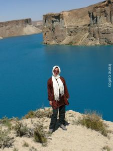 Our traveler posing with the lake beauty of Band-e Amir National Park behind her.